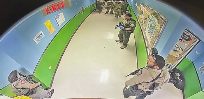 Authorities are seen waiting in the hallway instead of directly engaging with the shooter