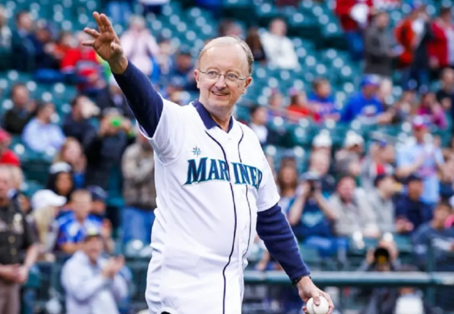 John Clayton on the field waving to his fans
