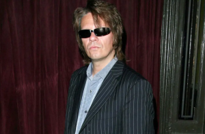 Andy Taylor flaunts youthful sunglasses and a lined suit